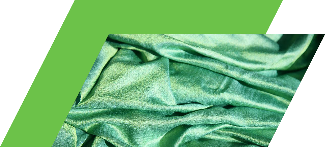 A close-up of soft, crumpled green fabric with a shiny texture.