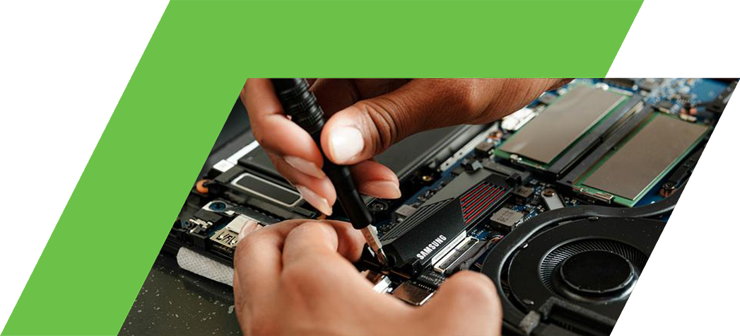 A person is using a precision screwdriver to work on the interior components of a laptop.