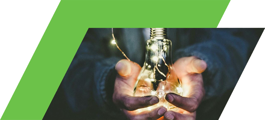 A person holds a glowing light bulb with fairy lights inside, symbolizing creativity and inspiration.