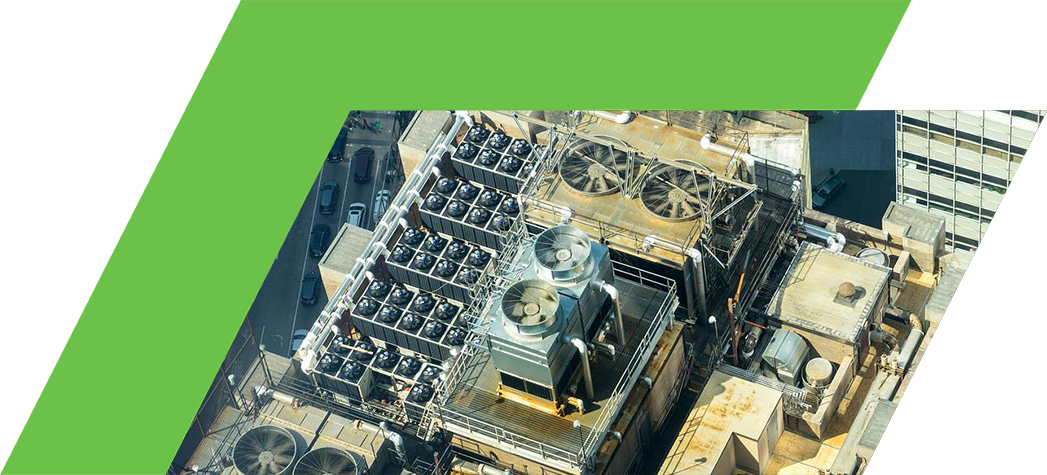 Aerial view of a rooftop with large cooling units and ventilation fans.