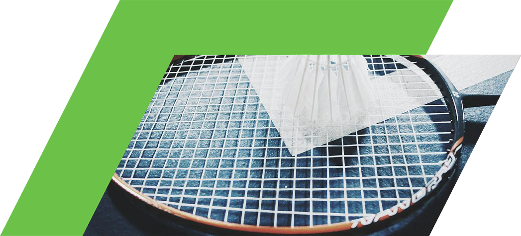 A badminton racket with a shuttlecock placed on it, set against a textured surface.