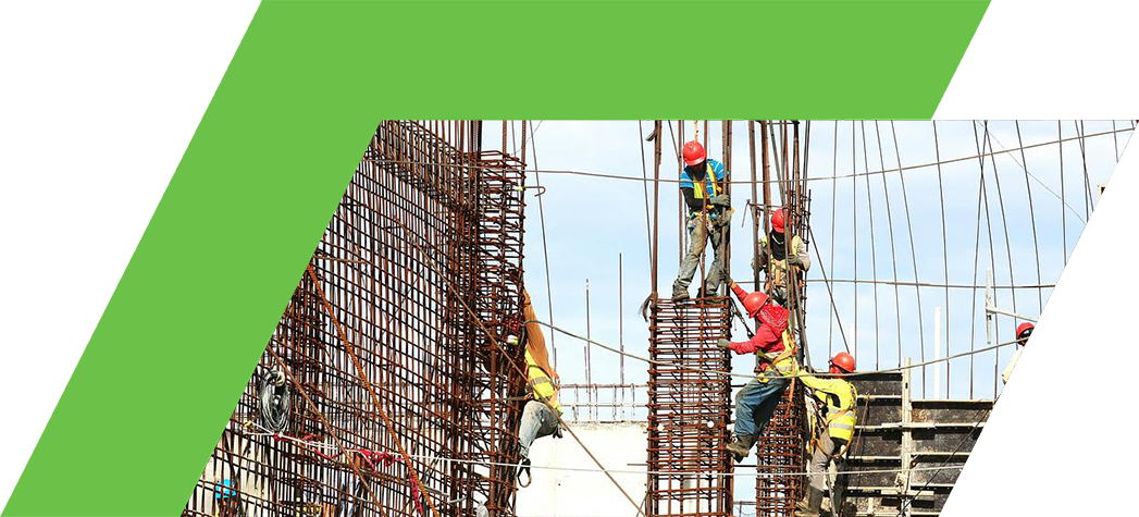 Construction workers wearing hard hats and safety gear are seen working on a large building site with rebar structures.
