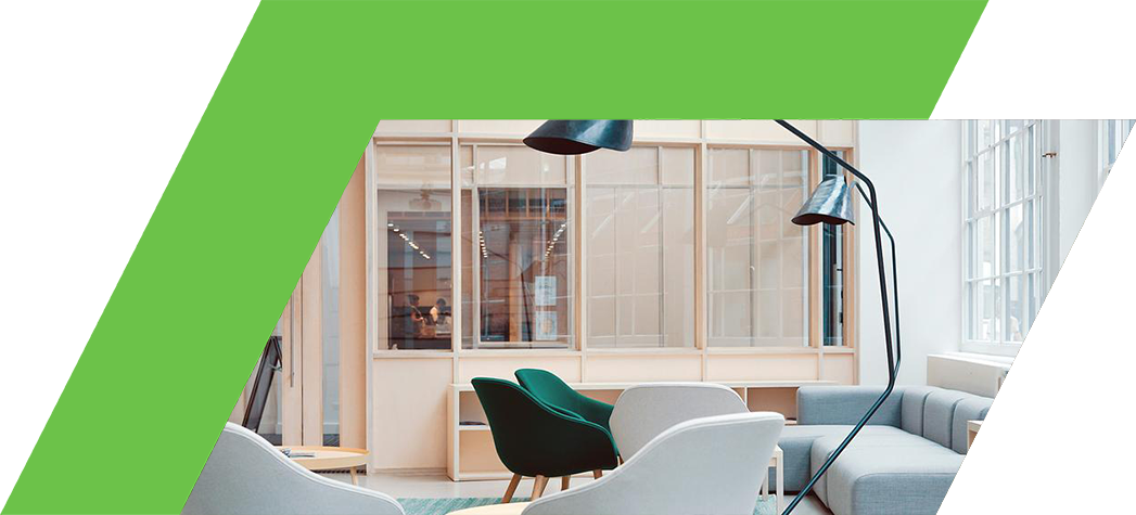 A modern and stylish lounge area featuring comfortable chairs, a sleek floor lamp, and large windows allowing natural light.