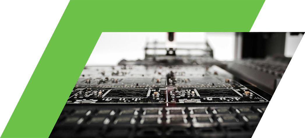 A close-up view of a printed circuit board under a robotic arm in a manufacturing setting.