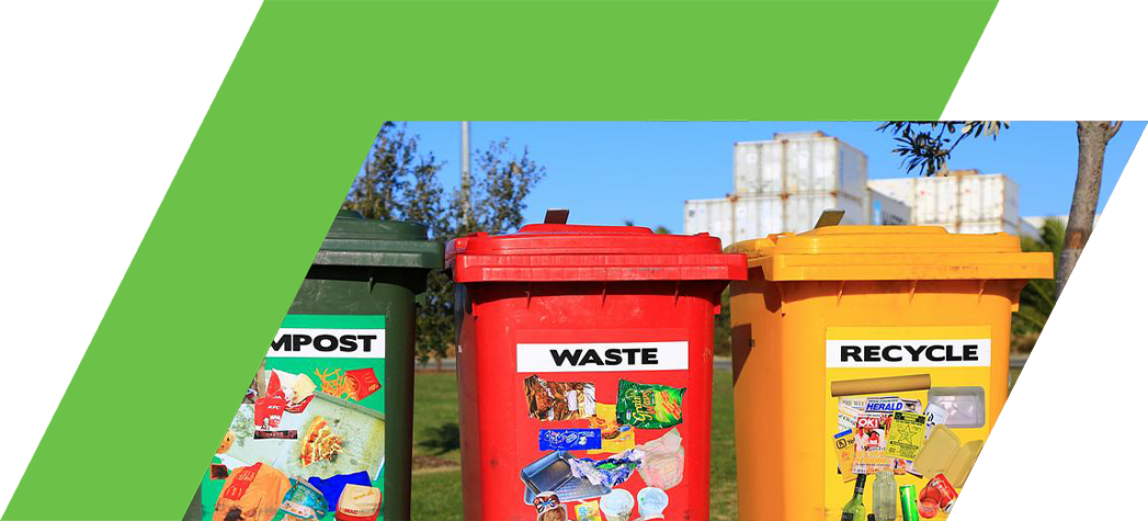 Three waste bins labeled for compost, waste, and recycling, each adorned with images of appropriate items for disposal.