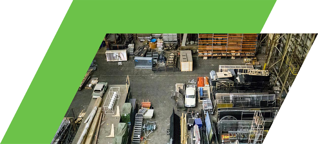An aerial view of a large industrial space filled with various construction materials and equipment.