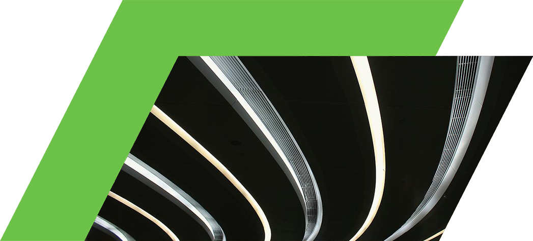 Abstract view of a modern ceiling featuring curved, illuminated lines against a dark background.