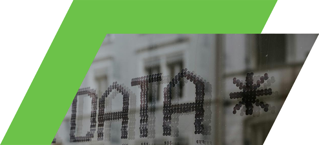 Close-up of a window displaying the word "DATA" made from circular stickers.