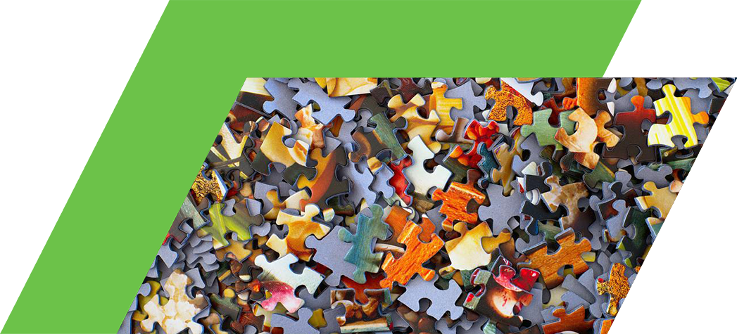 A colorful assortment of jigsaw puzzle pieces scattered across a surface.