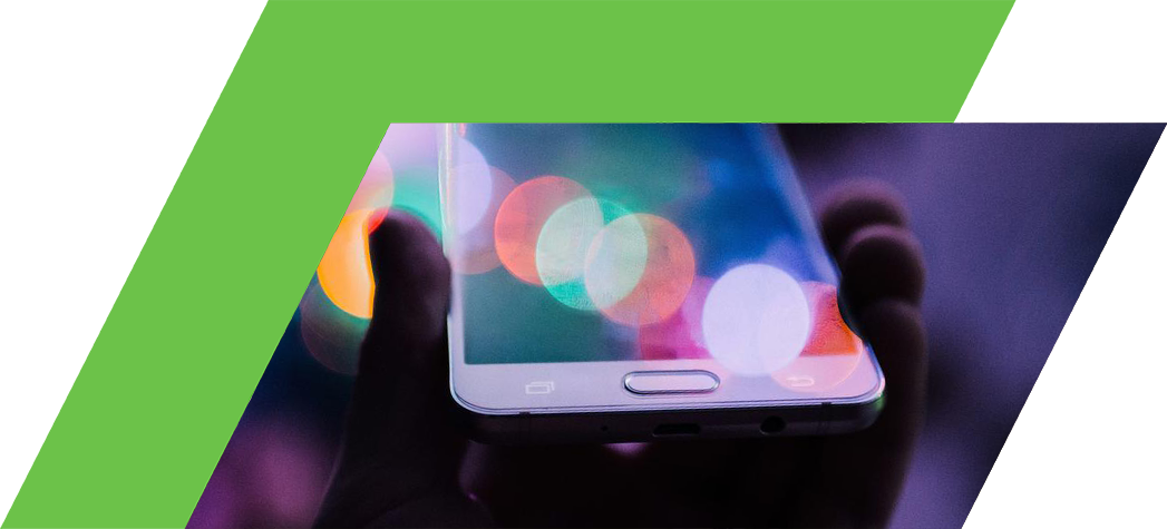 A hand holding a smartphone with a blurred, colorful background of lights.