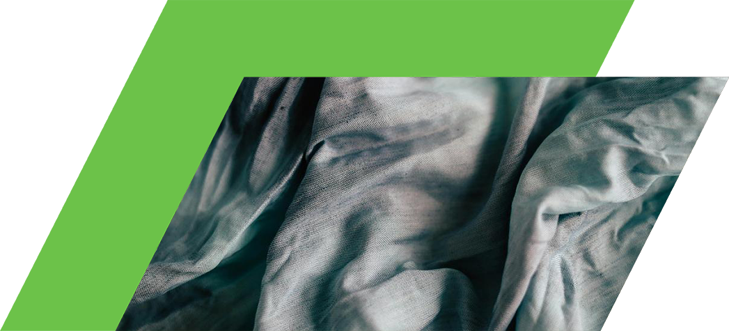 A close-up of crumpled, soft fabric featuring a blend of light blue and teal hues.