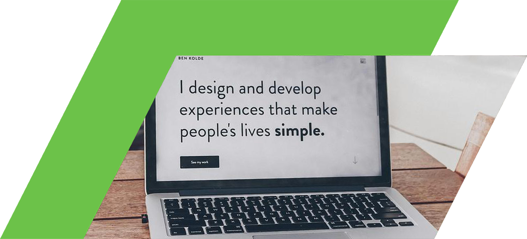 A laptop on a wooden table displays the text "I design and develop experiences that make people's lives simple."