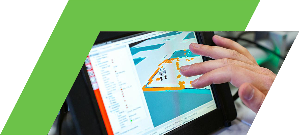 A hand interacts with a touchscreen displaying a digital map with outlined areas and data.