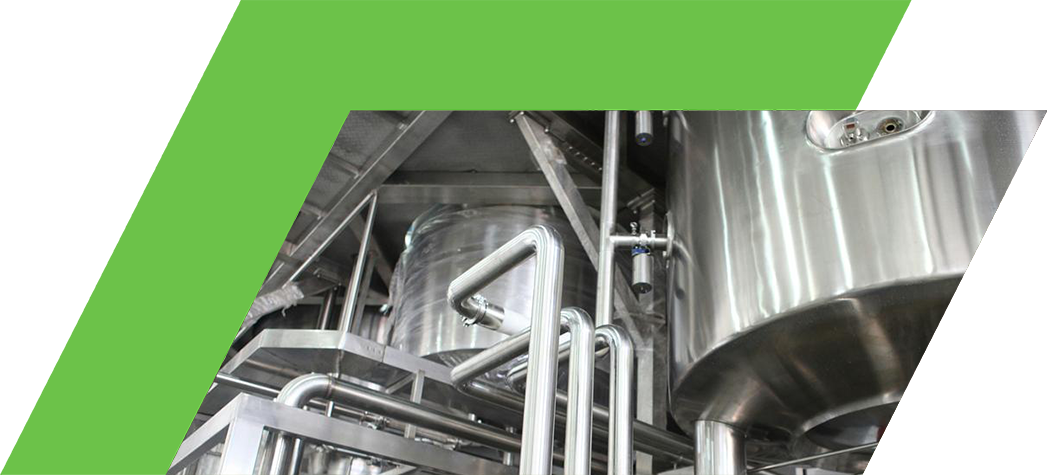 Industrial stainless steel pipes and tanks in a manufacturing facility.
