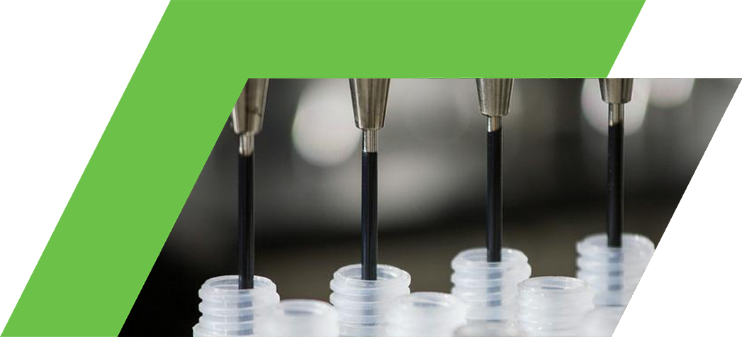 Close-up of laboratory pipetting equipment dispensing liquid into multiple small containers.