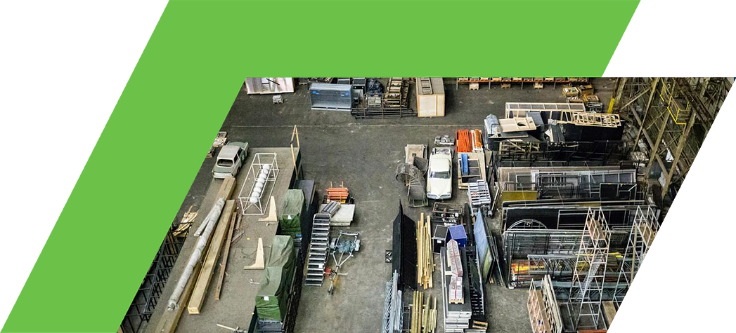 Aerial view of a large industrial storage area filled with various materials, equipment, and containers.