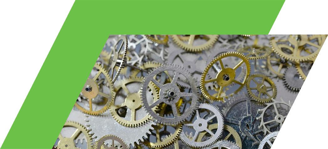 A close-up view of assorted metallic gears in various sizes and finishes scattered on a surface.