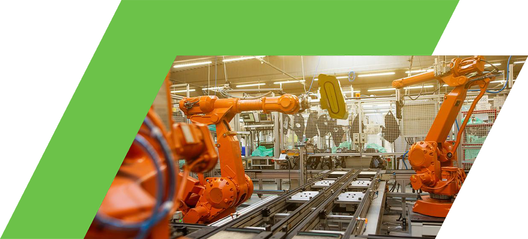 A factory setting featuring several orange robotic arms working on a production line.