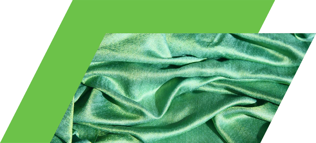 A close-up view of crumpled green fabric with a silky texture.