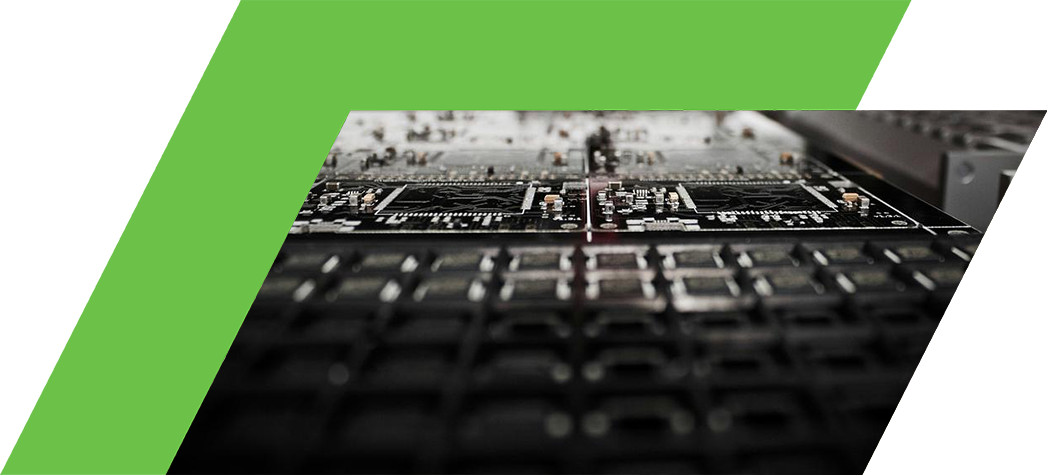A close-up view of a circuit board and electronic components in a manufacturing setting.