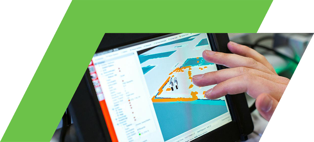 A hand interacts with a touchscreen displaying a digital map with various colored overlays.