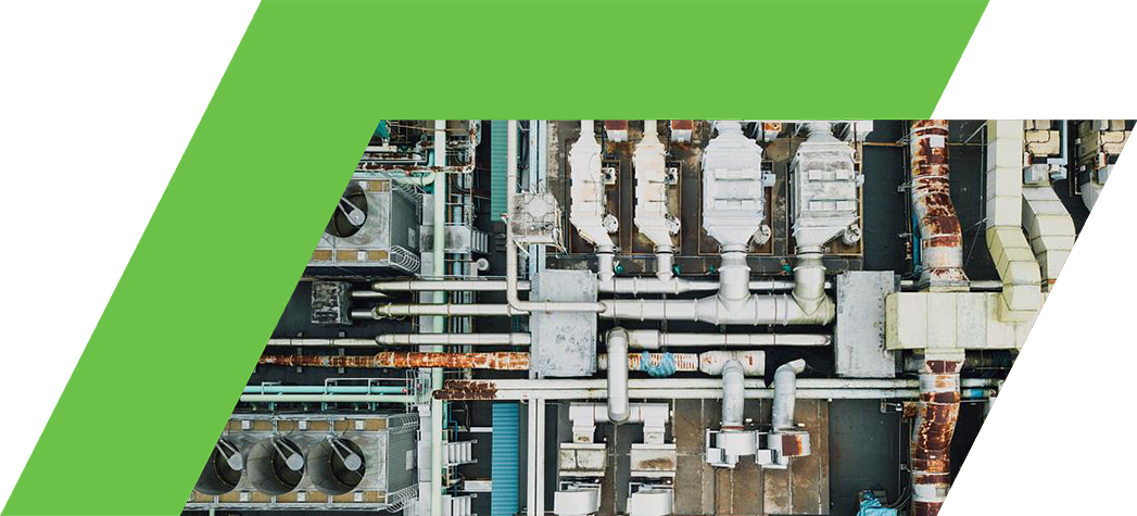 An aerial view of a complex industrial rooftop featuring numerous pipes, air conditioning units, and machinery.