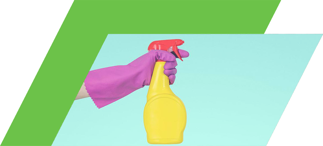 A hand wearing a pink rubber glove holds a yellow spray bottle against a mint green background.