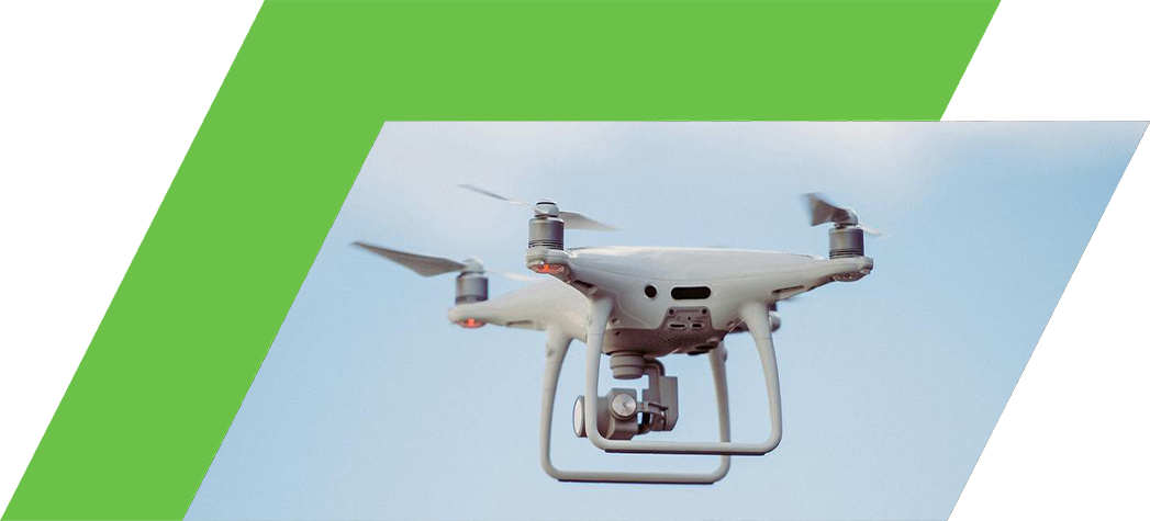 A white drone is flying against a blue sky with clouds.