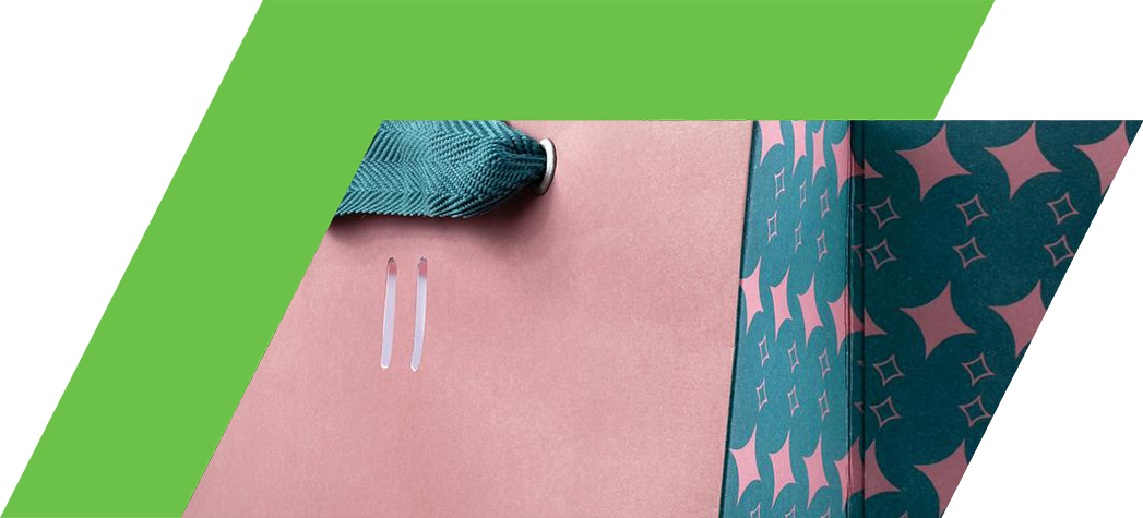 A stylish pink shopping bag with a teal patterned interior and a textured teal handle.