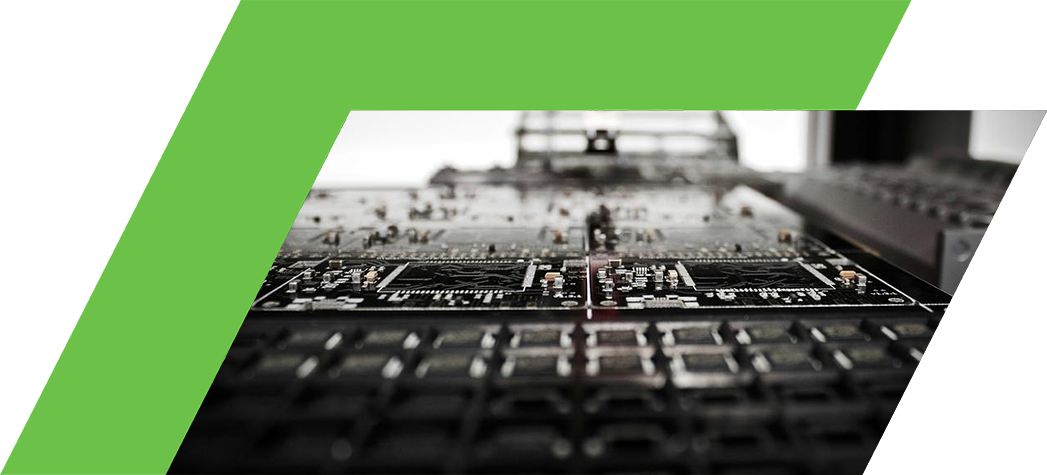 A close-up view of a printed circuit board being assembled with a robotic arm in a manufacturing setting.
