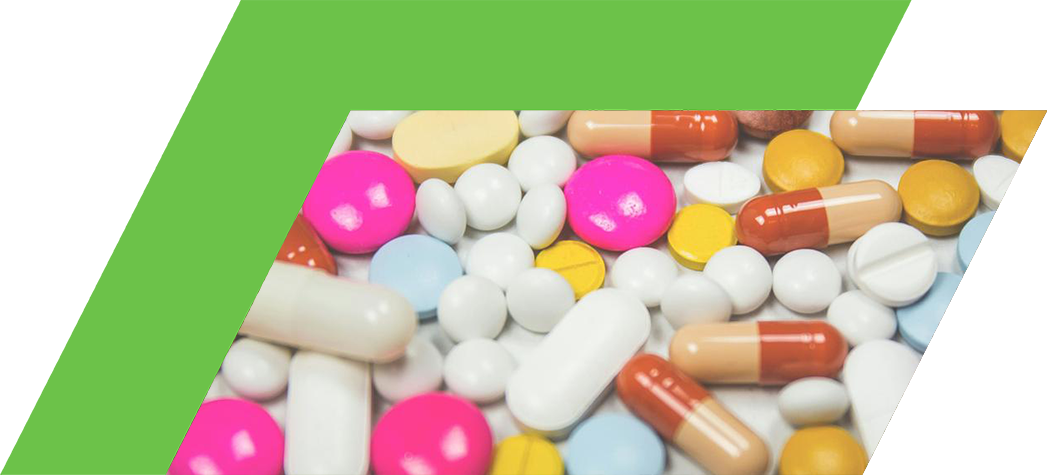 A variety of colorful pills and capsules scattered on a surface.