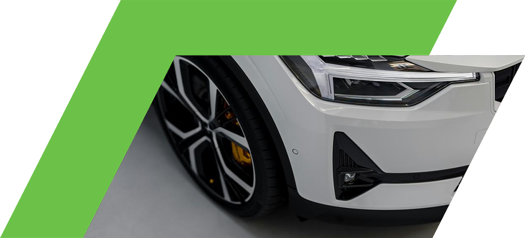 A close-up view of the front corner of a white luxury car showcasing its sleek design and modern headlights.
