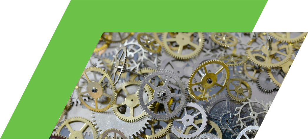 A close-up view of a pile of assorted metallic gears in various sizes and colors.