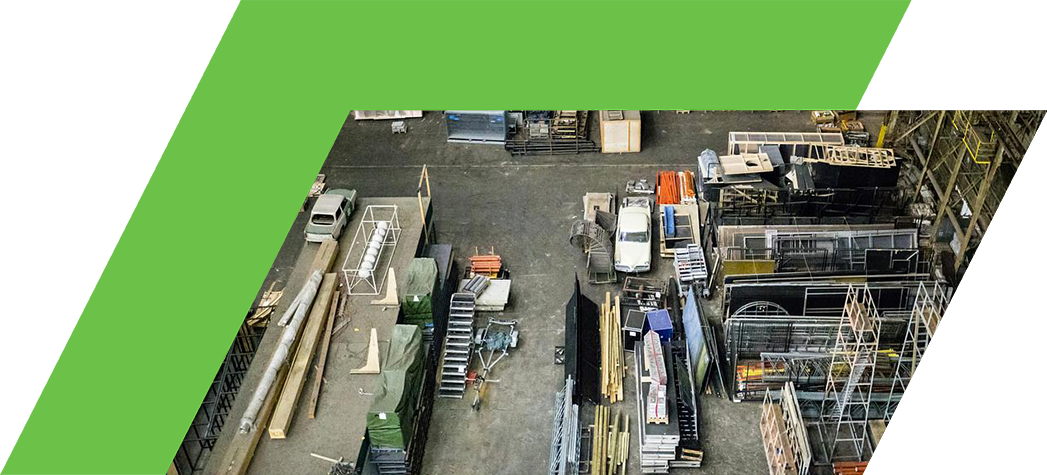 An aerial view of a complex industrial facility featuring pipes, cooling units, and machinery.