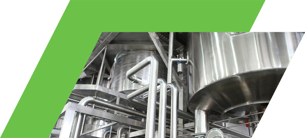 Industrial stainless steel machinery with pipes and tanks.
