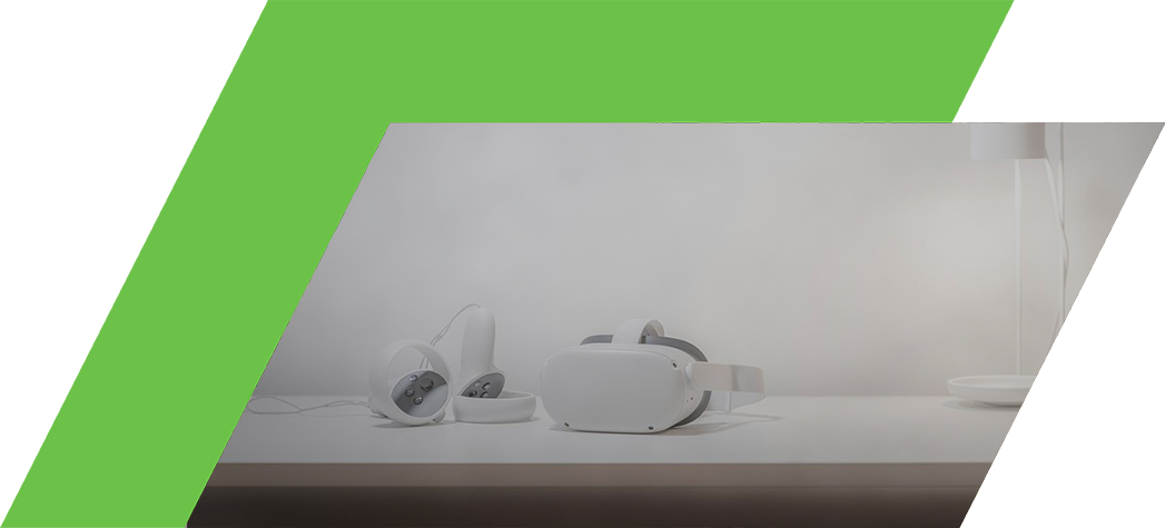 A pair of white virtual reality headsets and controllers sit on a minimalist white table next to a modern lamp.